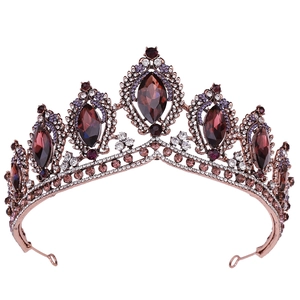 Detailed close-up of Baroque gold crown with marquise purple crystals and vintage rhinestones