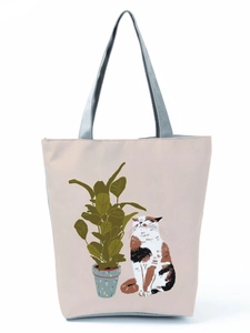 Detailed macro shot of the canvas fabric texture and cat illustration on the tote bag