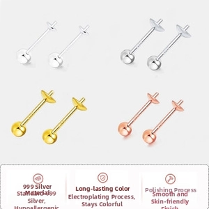 Close-up of four spherical silver stud earrings in gold, silver, black, and rose gold