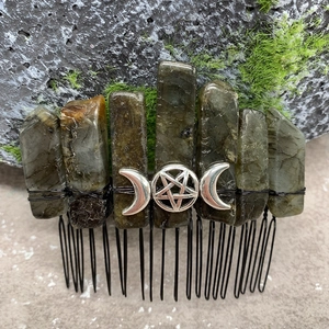 Macro detail of natural labradorite stones and moon symbol on handmade hair comb
