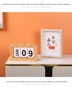 Close-up of wooden flip calendar and picture frame with calligraphy on white marble table