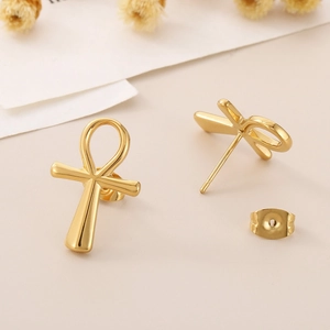 Detailed view of polished 18K gold-plated stainless steel Ankh cross stud earrings