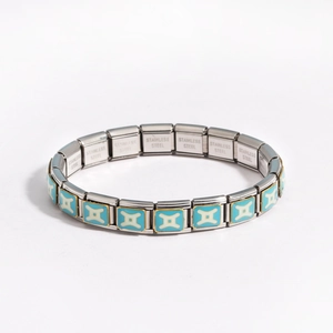 Detailed macro view of modular stainless steel bracelet links with blue star patterns