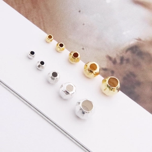 Macro shot of faceted S925 sterling silver beads in gold and silver for DIY jewelry