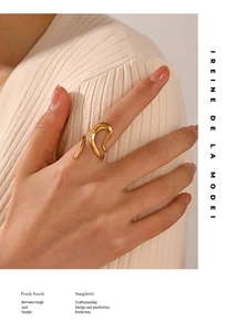 Detailed view of an 18K gold plated geometric wave ring on a woman's hand