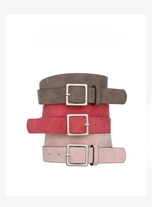 Close-up of matte PU leather belts with square metal buckles in brown, red, and pink colors