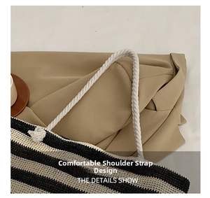 Detail of soft cotton rope handle and striped woven texture on large shoulder tote bag