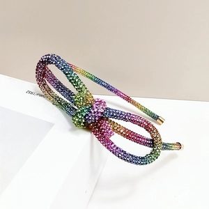 Sparkling knotted headband featuring gradient colorful rhinestones and gold tips