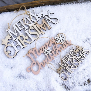 Three assorted wooden Merry Christmas hanging ornaments on snowy decorative background