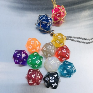 Colorful D20 resin dice set with metal cage pendants on a brushed metallic background
