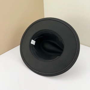 Detail view of the black fedora hat interior showing the 58 size label and material tag