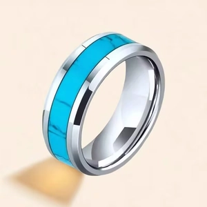 Close-up of a men's titanium steel ring with a vibrant turquoise stone inlay