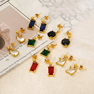Macro detail of geometric stainless steel earrings with colorful zircon gemstones