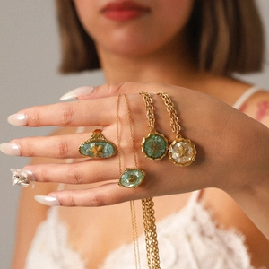 Golden starfish jewelry set with shell inlays featuring a ring and necklaces for beach style