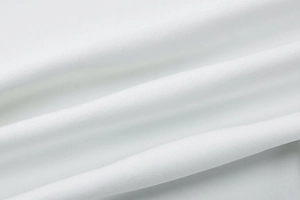 Macro shot of high-quality white dress fabric texture showing soft material detail