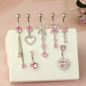 Detail of 7 pink zircon belly rings with heart, butterfly, and tassel designs in silver