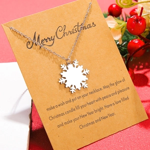 Silver snowflake pendant necklace with Merry Christmas gift card on festive red background