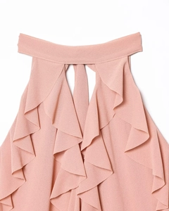 Detail of pink halter neck top featuring tiered ruffle layers and chiffon texture