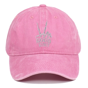 Close-up of pink washed cotton baseball cap with Good Vibes skeleton hand embroidery