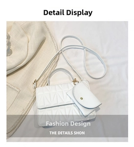 Detailed view of white quilted crossbody bag set with gold hardware and mini pouch
