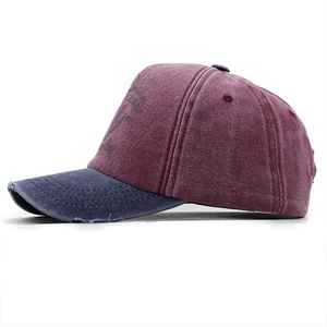 Detailed side view of washed vintage cotton baseball cap with distressed brim and anchor logo