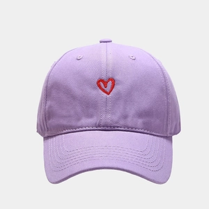 Close-up of heart embroidery on light purple cotton baseball cap with twill texture