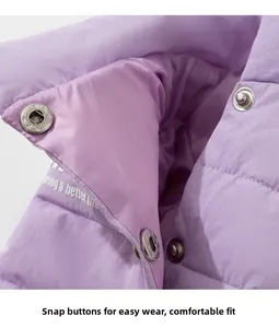 Detail of purple quilted dog jacket with snap fasteners and bring a better life print