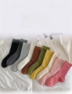 Flat lay of colorful ribbed cotton socks in ten pastel shades for women's daily wear