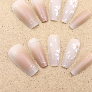 Autumn floral press-on nails with warm gradient shades and daisy patterns in long coffin shape