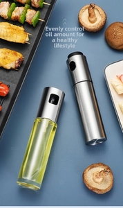 Top-down view of a glass oil sprayer bottle with professional stainless steel pump head
