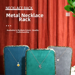 Three velvet jewelry stands in green, blue and grey with gold frames for necklace display