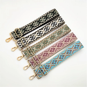 Detail showing five ethnic geometric patterned woven bag straps with gold metal hooks