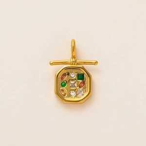 Macro detail of octagonal 18K gold plated pendant with colorful inlaid gemstones