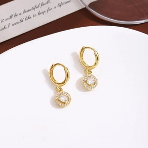 Detailed view of gold hoop earrings with halo-set round crystal pendants on display