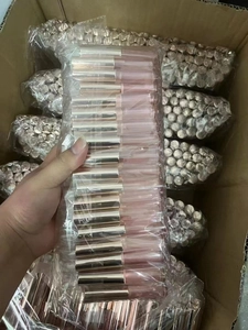 Bulk pack of clear lip gloss tubes with pink caps for beauty product packaging