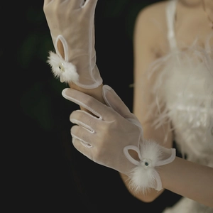 Elegant white sheer bridal gloves with delicate lace floral and plush wrist trim
