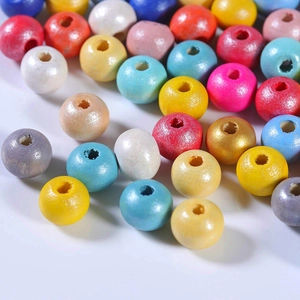 Macro shot of colorful round wooden spacer beads with central holes for jewelry making