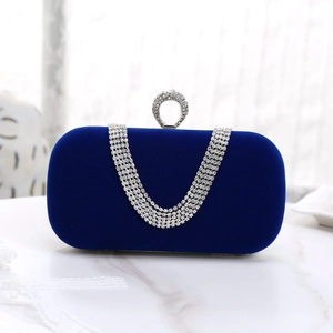 Detail view of the blue velvet evening clutch featuring diamond inlay and ring handle