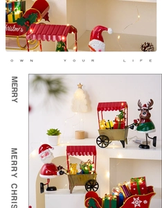 Detail of Christmas metal train decor with hand-painted Santa and reindeer motifs