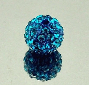 Macro shot of a blue crystal disco ball bead with rhinestones and reflection