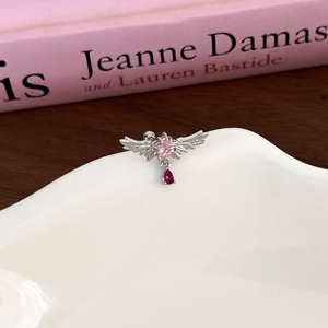 Detail of silver wing earring with pink star gemstone and red teardrop zircon pendant