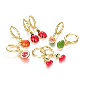 Macro detail of S925 sterling silver fruit charms including avocado and cherry earrings