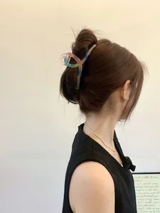 Side view of a 13cm gradient hair claw clip on wavy hair showing a minimalist twist design