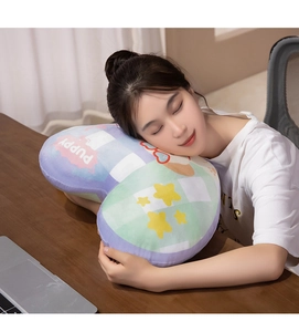 Detail of soft heart-shaped plush pillow with plaid pattern for office napping