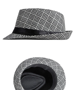 Detail view of woven straw jazz hat texture and inner lining with black satin ribbon
