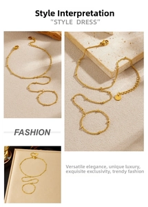 Close-up of golden beaded hand chain ring with dainty link chain and lobster clasp closure