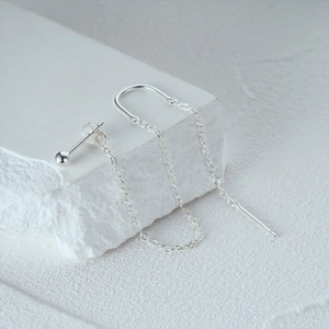 Macro detail of S925 sterling silver tassel earring with U-hook on natural white stone