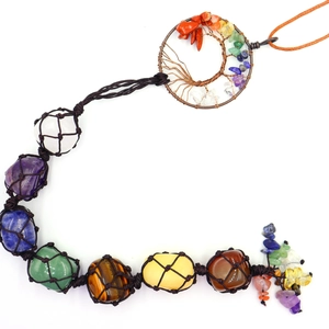 Close-up of tree of life chakra hanging with seven natural polished healing crystals