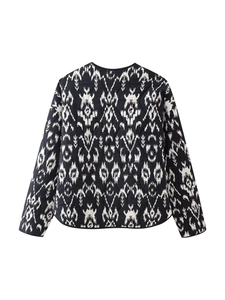 Detail view of ethnic quilted jacket featuring black and white ikat pattern and back stitching