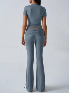 Rear view of grey slim-fit short-sleeve top and flared yoga pants set for women